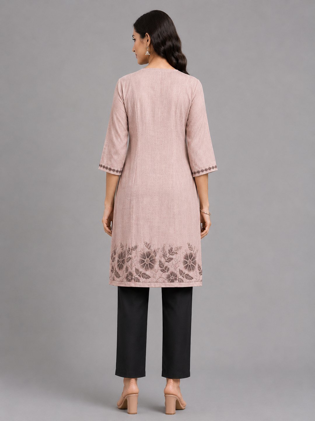 Rose linen tunic with tapered black trousers, back